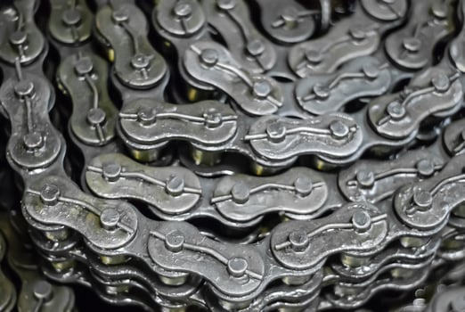 industrial background - rolled up drive chains in stock photo