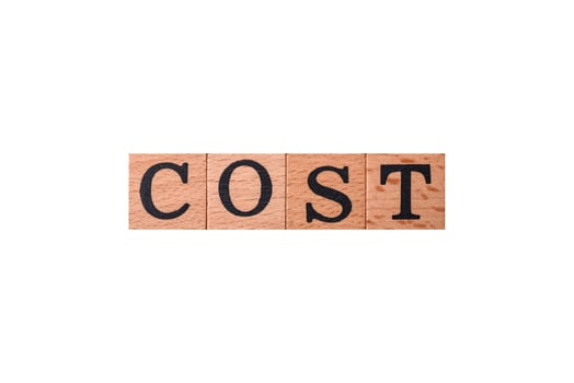 The inscription cost in wooden cubes on a dark concrete background photo