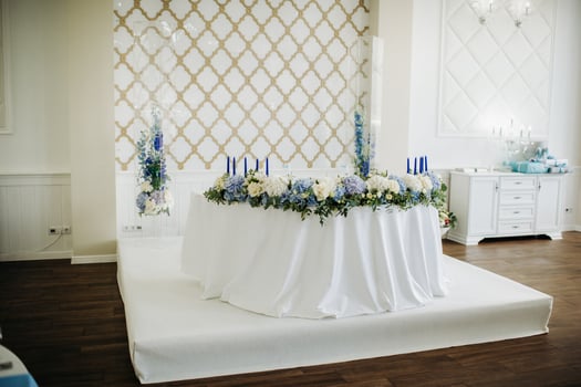 Wedding bride and groom table presidium decorated with a lot of flowers photo