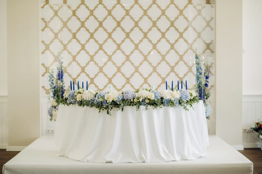Wedding bride and groom table presidium decorated with a lot of flowers photo