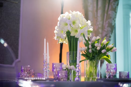 decoration of a festive dinner with Lily flowers on the wedding table in the interior of the restaurant.Wedding decor. photo