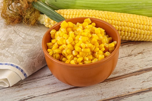 Canned yellow corn in the bowl photo
