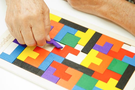 Asian elderly woman playing puzzles game for treatment dementia prevention and Alzheimer disease. photo