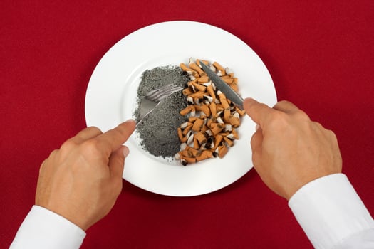 man eating cigarette butts photo