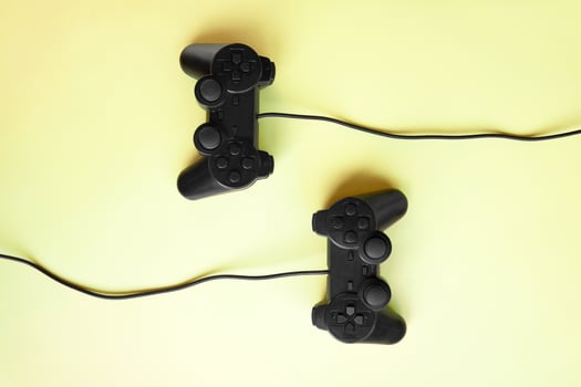 Two joystick gaming controlle on yellow background. photo
