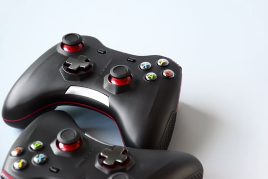 Two joystick gaming controller on light blue background. Minimalism. photo
