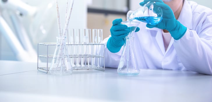 Doctor or scientist using pipette to drop a sample to test tube in medical research lab or science laboratory photo