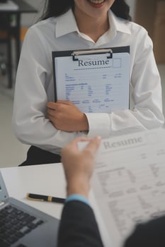 Close up view of job interview in office, focus on resume writing tips, employer reviewing good cv of prepared skilled applicant, recruiter considering application, hr manager making hiring decision photo