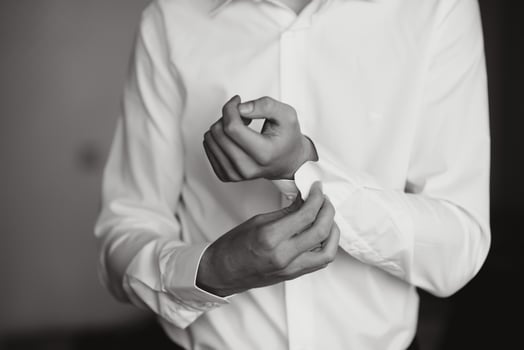 A man fastens buttons on his shirt photo