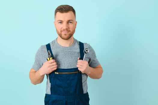 Portrait of smiling worker in uniform isolated on blue background photo