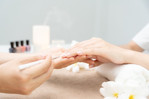 Woman receive care service by professional Beautician Manicure at spa centre. Nail beauty salon use nail file for Glazing treatment. manicurist make nail customer to beautiful. body care spa treatment photo