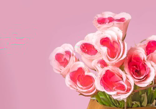 Valentine's Day concept. Bouquet of pink roses in box on pink background with copy space photo