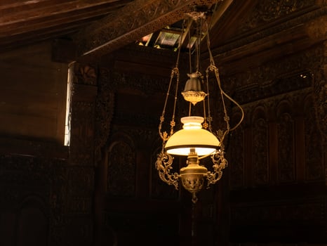 Antique lamp light up in a dark traditional house photo