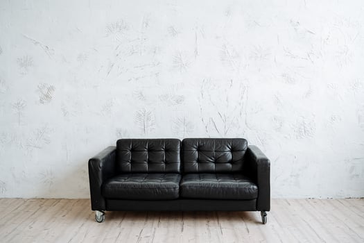 Perfect black leather sofa in a minimalist style. Modern furniture, convenience and comfort photo