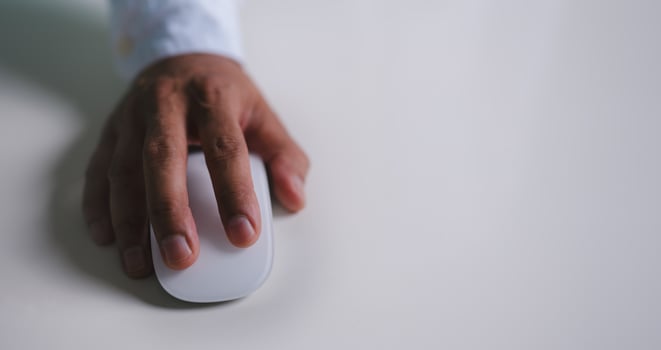 Close up of hand using on white mouse and clicking on office table photo