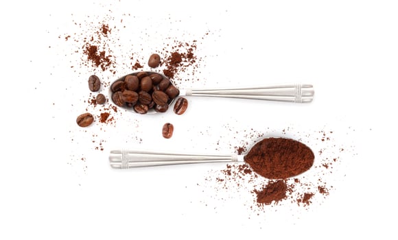 Spoons with coffee beans and coffee powder isolated on white photo