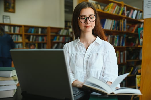 Portrait of a beautiful student in a library photo