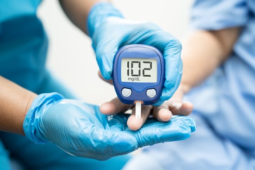 Doctor check diabetes from finger blood sugar level with finger lancet. photo