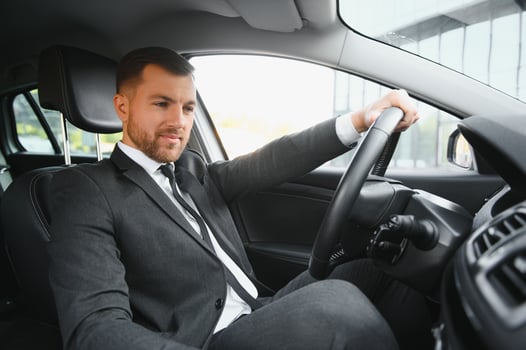 Attractive elegant happy man in good car photo