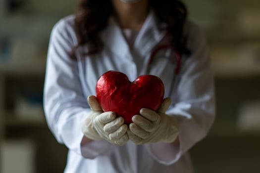 AI generated a female doctor holding a red heart photo