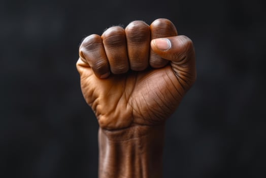 Raised fist of an African American black man in the background. Unity, solidarity, protest. black history month photo