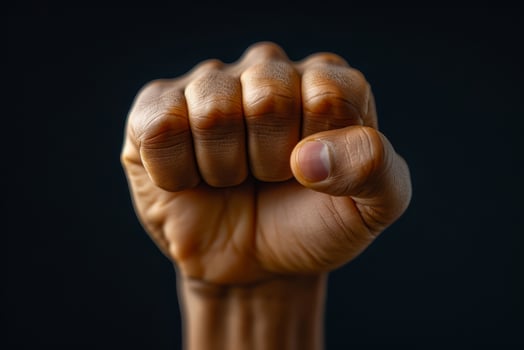 Raised fist of an African American black man in the background. Unity, solidarity, protest. Concept of black history month photo