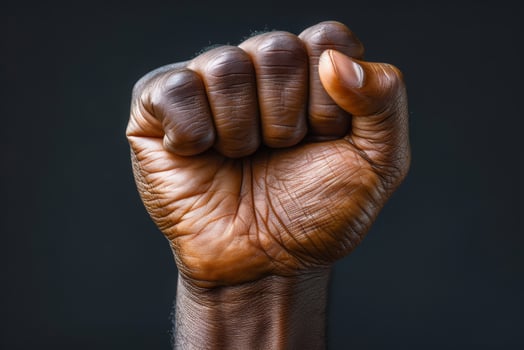 Raised fist of an African American black man in the background. Unity, solidarity, protest. Concept of black history month photo