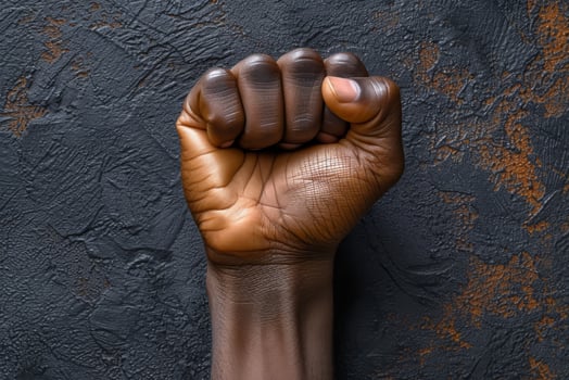 Raised fist of an African American black man in the background. Unity, solidarity, protest. Concept of black history month photo