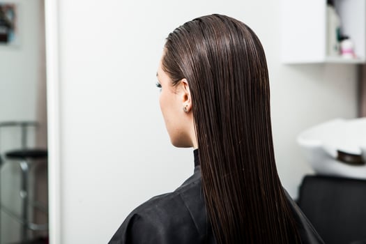 Portrait of a beautiful woman with long brown straight hair in a beauty salon. photo