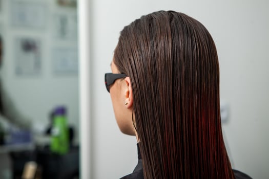 Portrait of a beautiful woman with long brown straight hair in a beauty salon. photo
