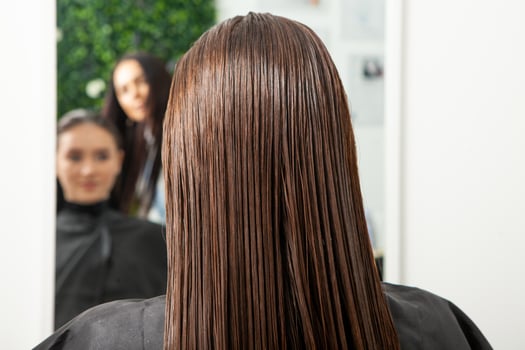 Portrait of a beautiful woman with long brown straight hair in a beauty salon. photo