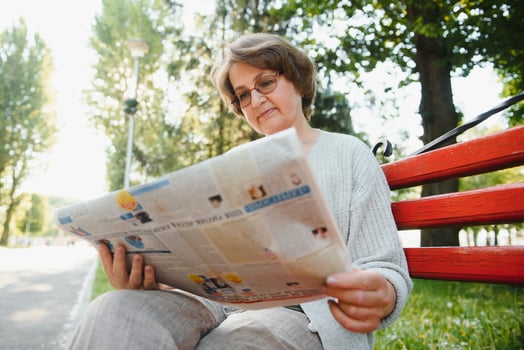 Portrait of a happy Senior woman in summer park photo