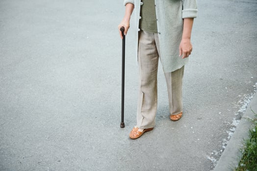 Woman with her walking stick in the park. photo