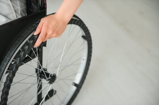 Young woman sitting in a wheelchair photo