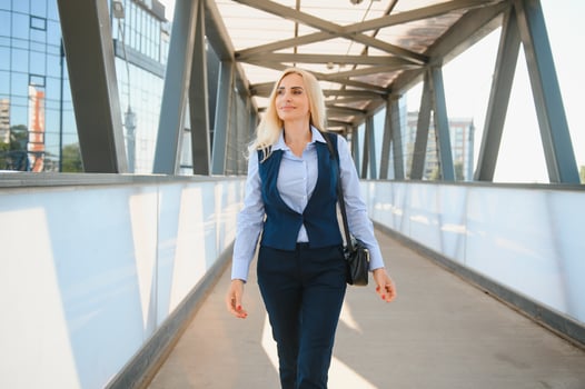 Close up portrait of a serious business woman in blue suit standing in the city photo