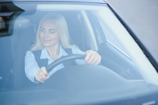 Portrait of business elegant middle-aged woman in car. photo