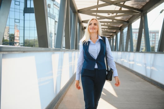 Close up portrait of a serious business woman in blue suit standing in the city photo