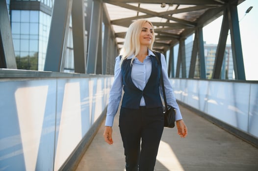 Beautiful Woman Going To Work, Business Woman Walking Near Office Building. Portrait Of Successful Business Woman. photo