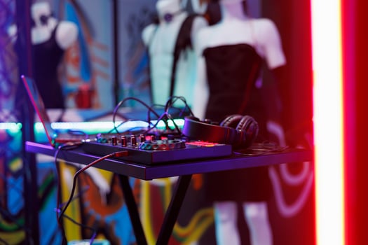 Dj music mixer equipment live concert and discotheque at nightclub stage. Musician controller for sound and volume mixing and headset for live performance in club with spotlight glow close up photo