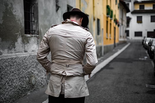 Detective walking in the city slums, view from the back photo