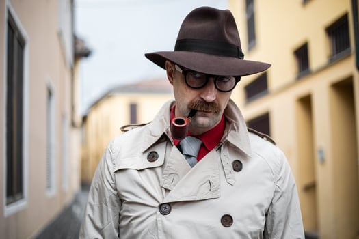 Vintage detective smoking a pipe outdoor in a grungy environment photo