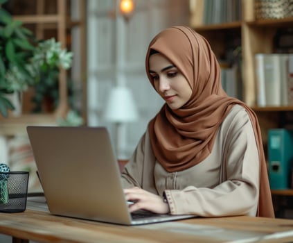 AI generated Muslim young woman works at desk with laptop, ramadan at workplaces picture photo