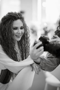 portrait of a bride with green curly hair in the beauty room photo
