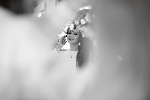 portrait of a bride with green curly hair in the beauty room photo