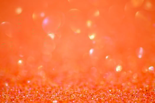Sparkles defocus light. Glitter paper defocus as background. Orange. photo