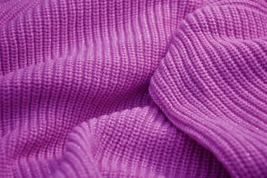 Texture of purple lilac knitwear for background. Rib knit sweater. photo
