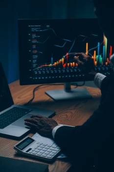 Thoughtful focused successful caucasian male stock investor, broker, financial adviser, sits at work desk, looks at computer, pensively analyze risks and prospects, rise or fall of cryptocurrency coin photo