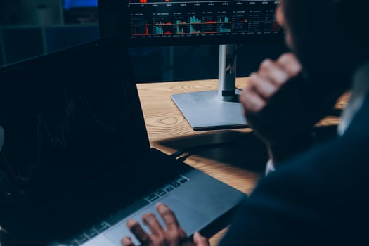 Thoughtful focused successful caucasian male stock investor, broker, financial adviser, sits at work desk, looks at computer, pensively analyze risks and prospects, rise or fall of cryptocurrency coin photo