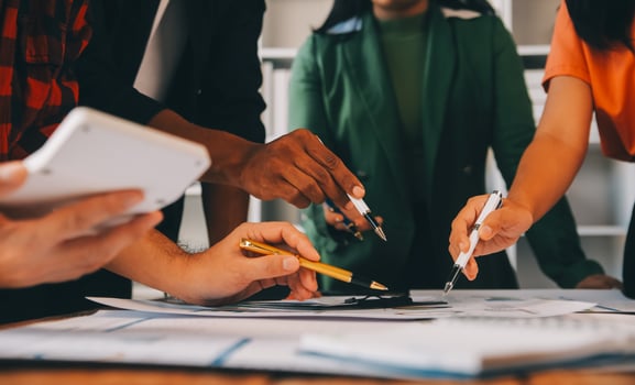 Male mature caucasian ceo businessman leader with diverse coworkers team, executive managers group at meeting. Multicultural professional businesspeople working together on research plan in boardroom. photo