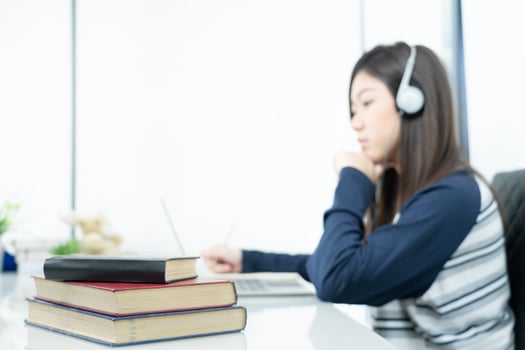 Young female long hair sitting in living room and learning online photo